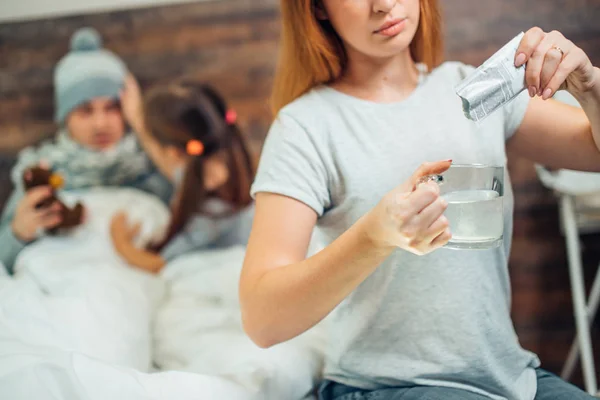 Cropped woman using medicaments to treat husband — Stock Photo, Image