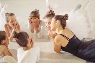 young ballerina lying on floor with kids