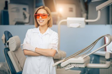 Portrait of smiling attractive dentist in clinic