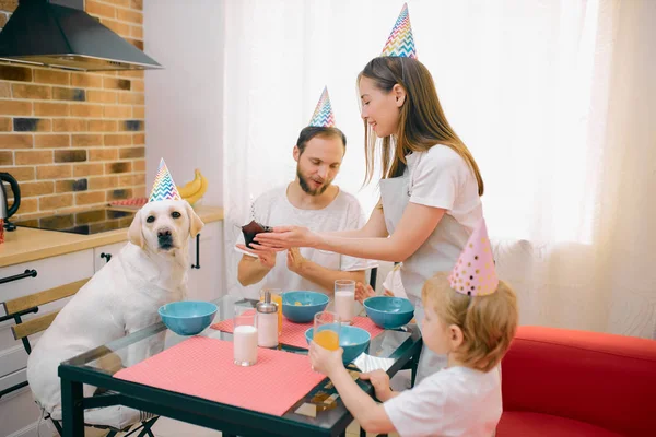 Krásná rodina trávit čas spolu doma se psem — Stock fotografie
