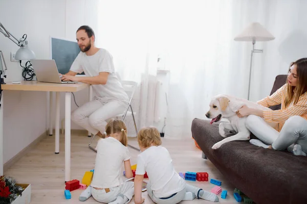 Giovane bella famiglia trascorrere il tempo libero a casa insieme — Foto Stock