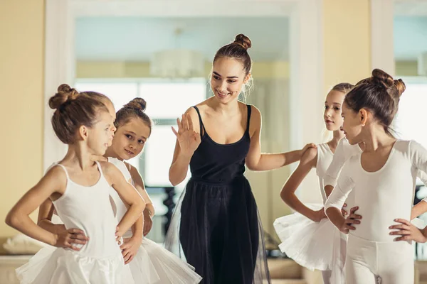 Giovane bella insegnante di balletto allenatore insegnare ai bambini piccoli — Foto Stock