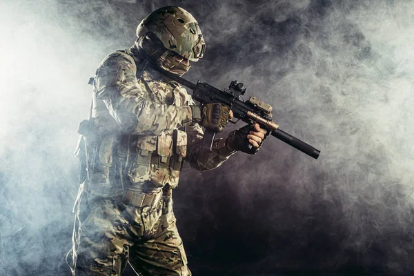 Portrait of young caucasian soldier with rifle — Stock Photo, Image