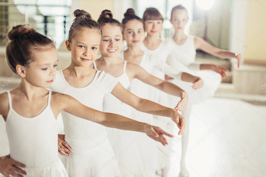 Young happy little ballerinas in a dance class