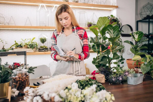 Young florist lady with notebook — Stock Photo, Image