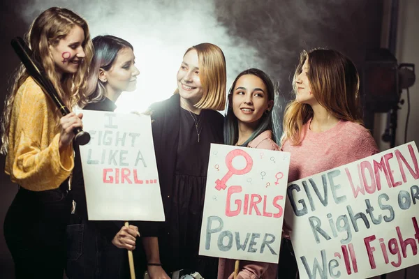 smiling happy feminists women together in smoky space