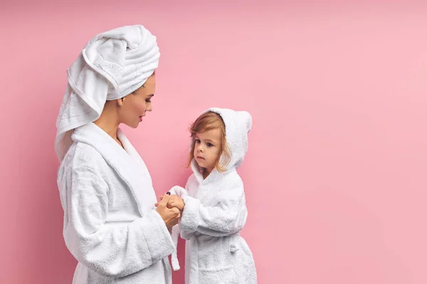 Madre en toalla blanca mira a la hija después de bañarse —  Fotos de Stock