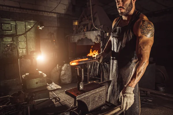 Side view on blacksmith shop owner at work — Stock Photo, Image