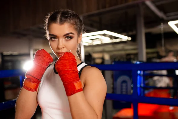 Muscular woman boxer isolated in gym