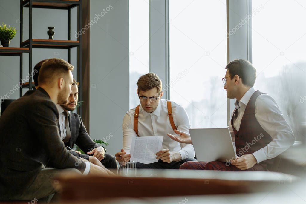 Business team coworking analyzing and commenting reports sitting at table