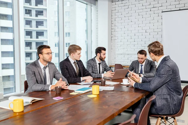 Young boss with colleagues in office — Stock Photo, Image