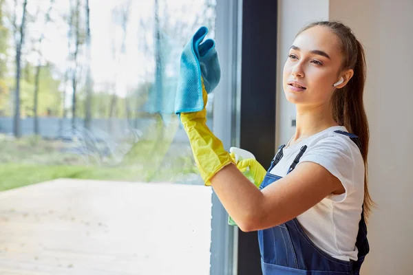 Modern young cleaning service washing window — ストック写真