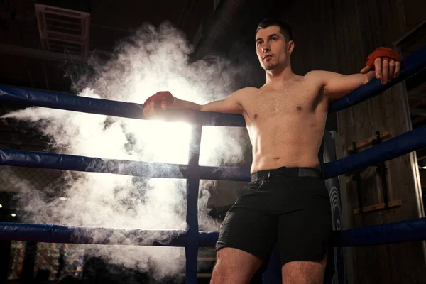 Young caucasian boxer man in smoky ring — Stock Photo, Image