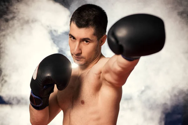 Portrait of muscular strong boxer man in smoke — Stock Photo, Image