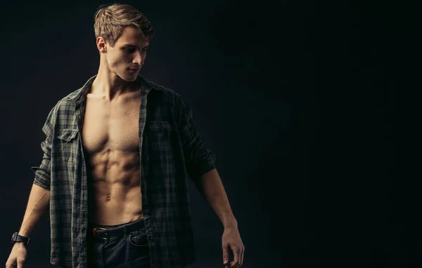 young man with muscular body in studio