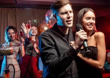 young caucasian couple in karaoke club