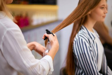 modern hairdresser doing her work in beauty saloon