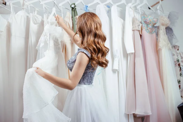 Young beautiful woman choose dress for wedding — 스톡 사진