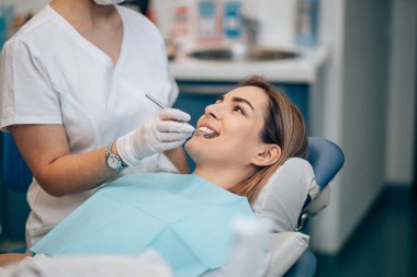 careful professional dentist woman treating teeth