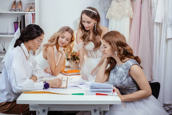 caucasian group of women gathered in designers office