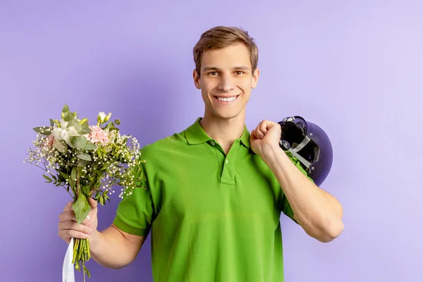 Delivery man with flowers isolated on purple — 스톡 사진