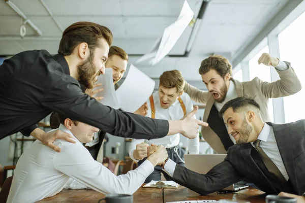 Cheerful joyful colleagues enjoy free time at work place — ストック写真