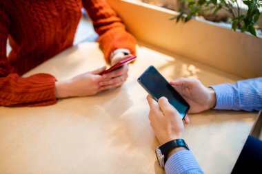 close-up of people using smartphone
