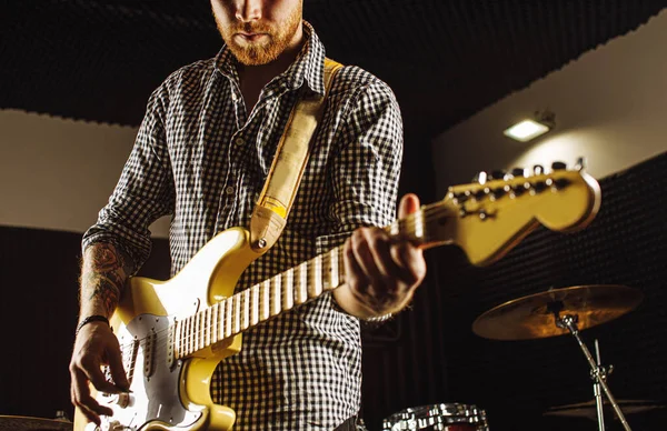 cropped man perform music with the use of electric guitar