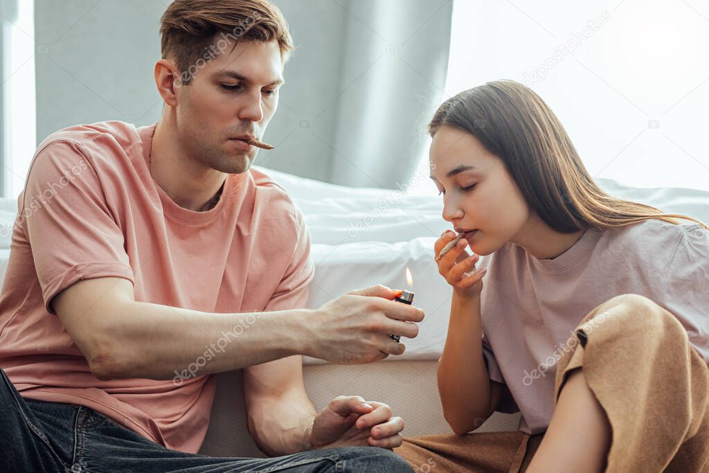 young caucasian couple use cannabis weed, catch a buzz together