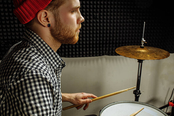 modern caucasian man play on drums