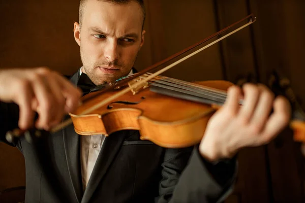 close-up portrait of caucasian man playing violin