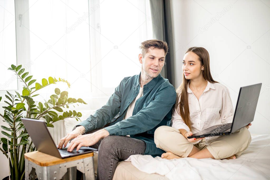 young married couple use their presonal laptop