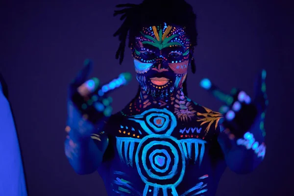 Cool boy with fluorescent make-up show fuck gesture — Stockfoto