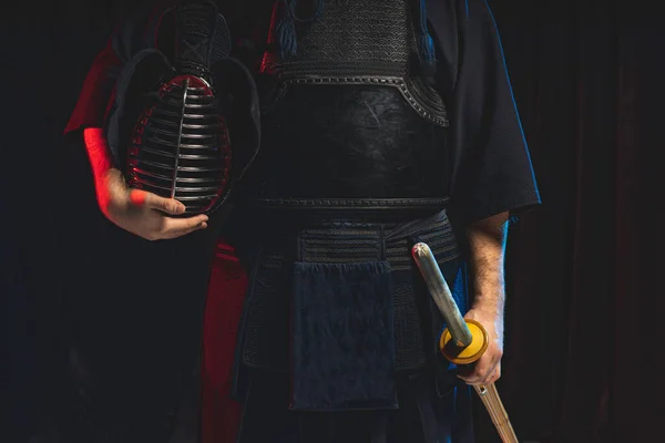 Cropped kendo male holding helmet and shinai sword in hands — Stock Photo, Image