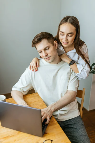 careful wife support her husband while he is working from home