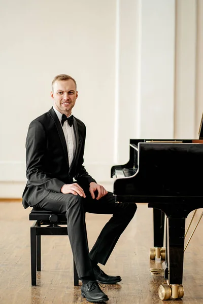 good-looking pianist male sit posing at camera