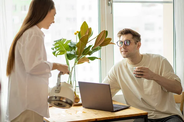 kind woman treats her husband with tasty tea while he is working