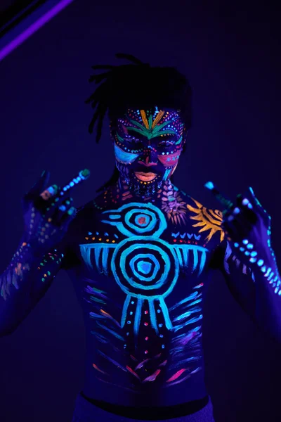 Cool boy with fluorescent make-up show fuck gesture — Stock Fotó
