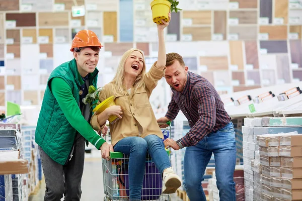 Positive staff roll the trolley with customer — Stock Photo, Image