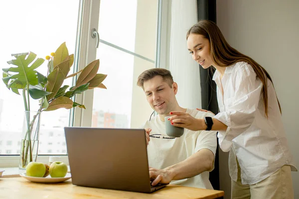 Attraktive Dame unterstützt Ehemann bei der Arbeit zu Hause — Stockfoto