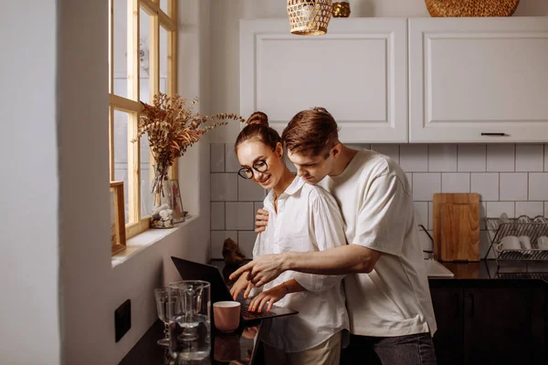 Handsome man hugs her working wife — Stock Photo, Image