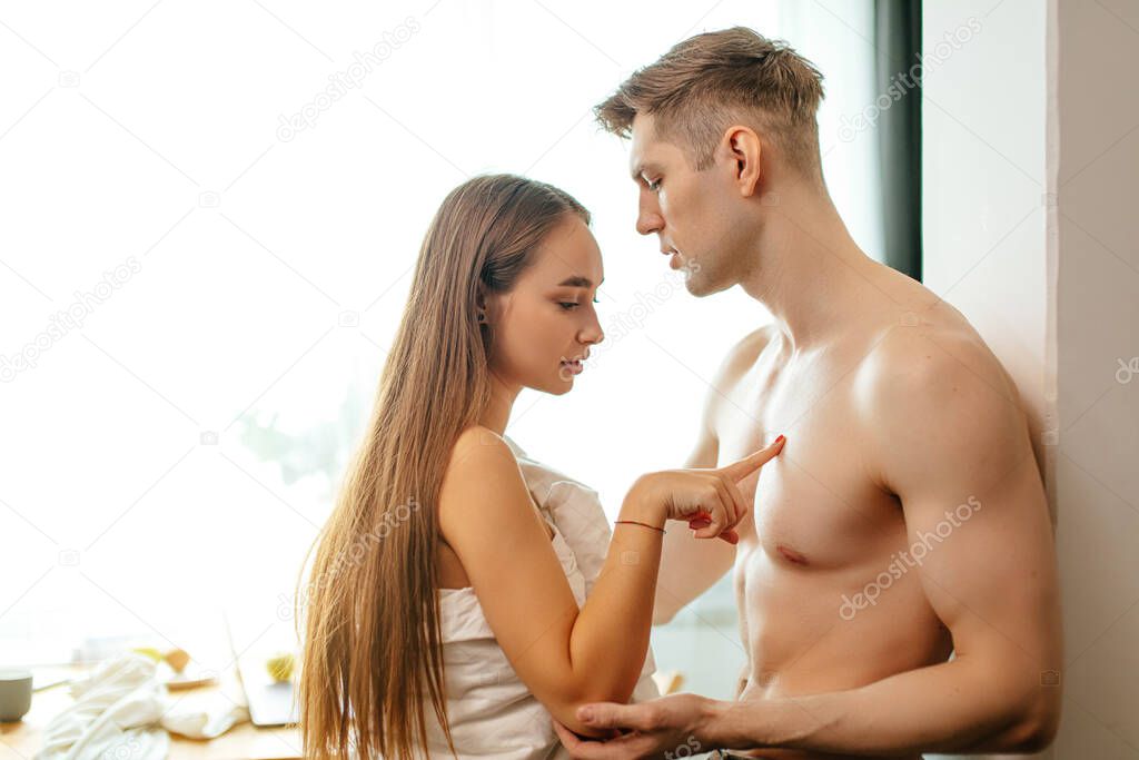 young sensual caucasian couple at home before having sex