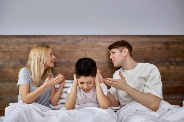 Little child tired of quarrels mom and dad — Stock Photo, Image