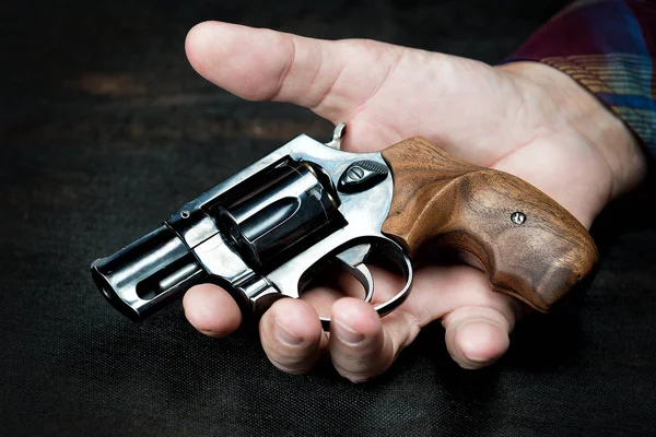 Old small revolver lies in a mans hand Stock Photo