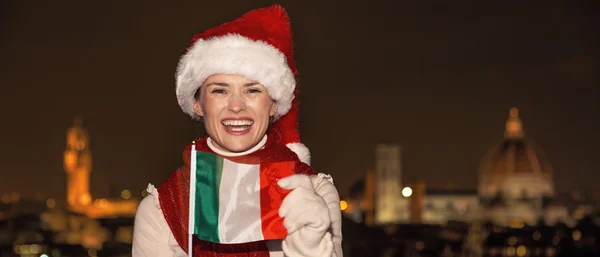 Woman in Christmas hat at Piazzale Michelangelo showing flag — Φωτογραφία Αρχείου