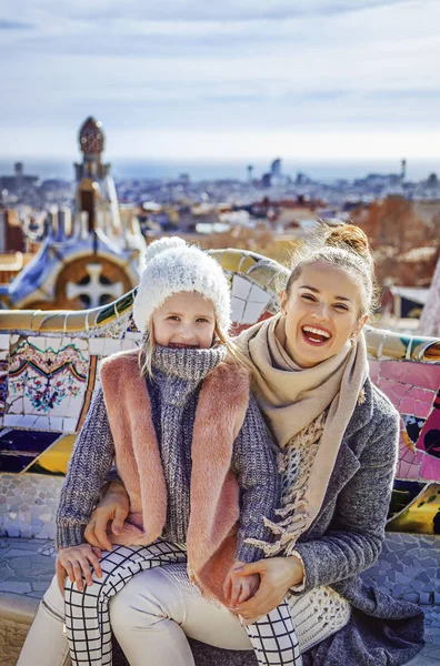 Szczęśliwa matka i dziecko turystów Park Guell siedząc na ławce — Zdjęcie stockowe