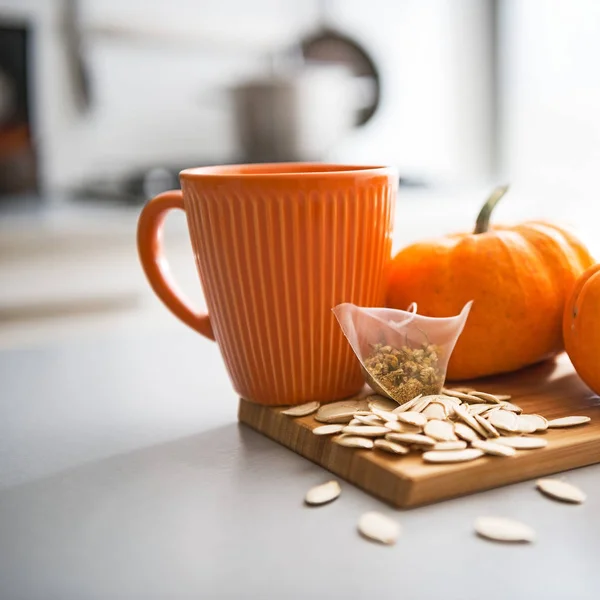 Close-up em pequenas sementes de abóboras e saco de chá na mesa — Fotografia de Stock