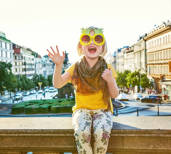 Happy girl in Prague in pineapple sunglasses handwaving — Stock Photo, Image