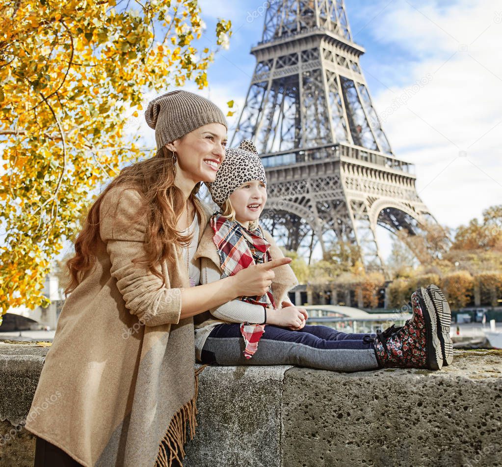 mother and child travelers in Paris pointing on something