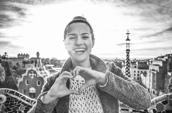 Femme souriante à Guell Park montrant les mains en forme de coeur — Photo